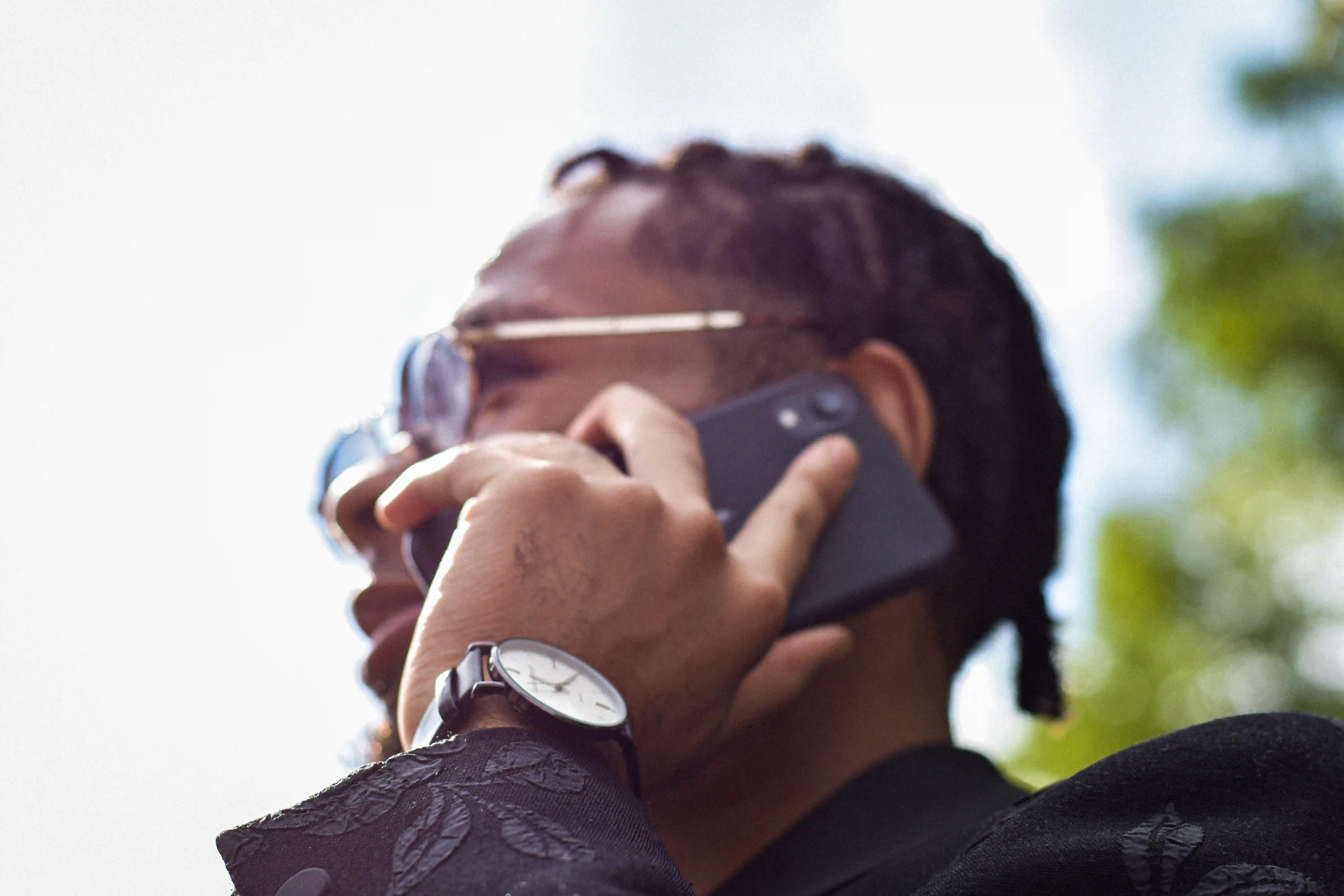 A creative professional speaking on a phone outdoors