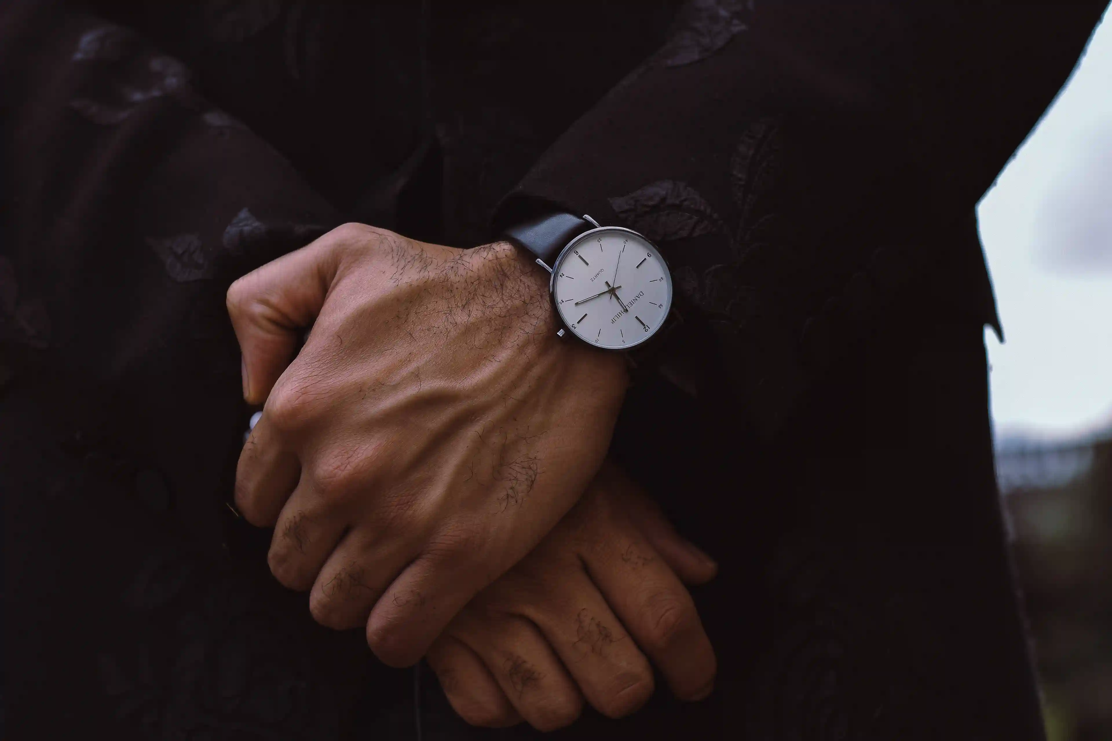 Editorial product photograph featuring a minimalist wristwatch